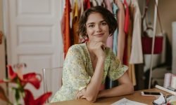 browneyed-shorthaired-young-lady-stylish-floral-summer-dress-looks-into-camera-smiles-gently-poses-cozy-room_197531-29853